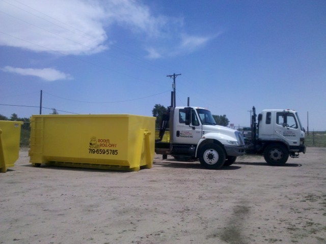 One Rolloff Container and Two Trucks