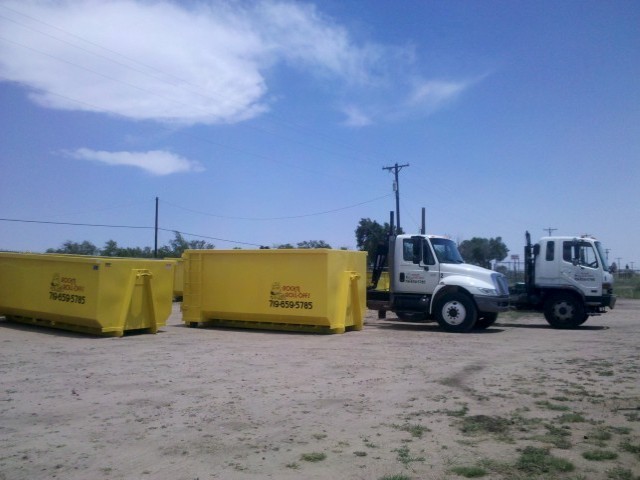 Two Rolloff Containers and Two Trucks