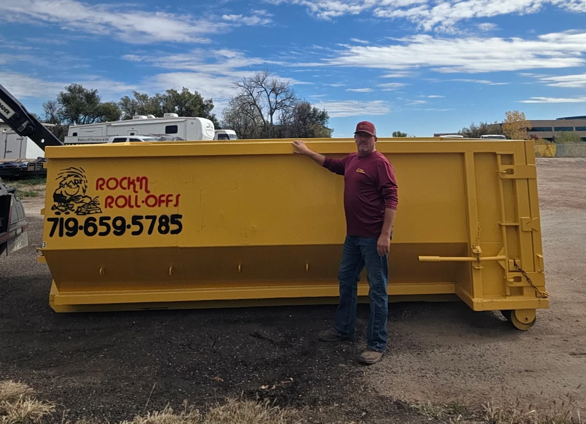15 cubic yard Rock'n Roll-Offs roll-off dumpster with a person standing beside it for scale